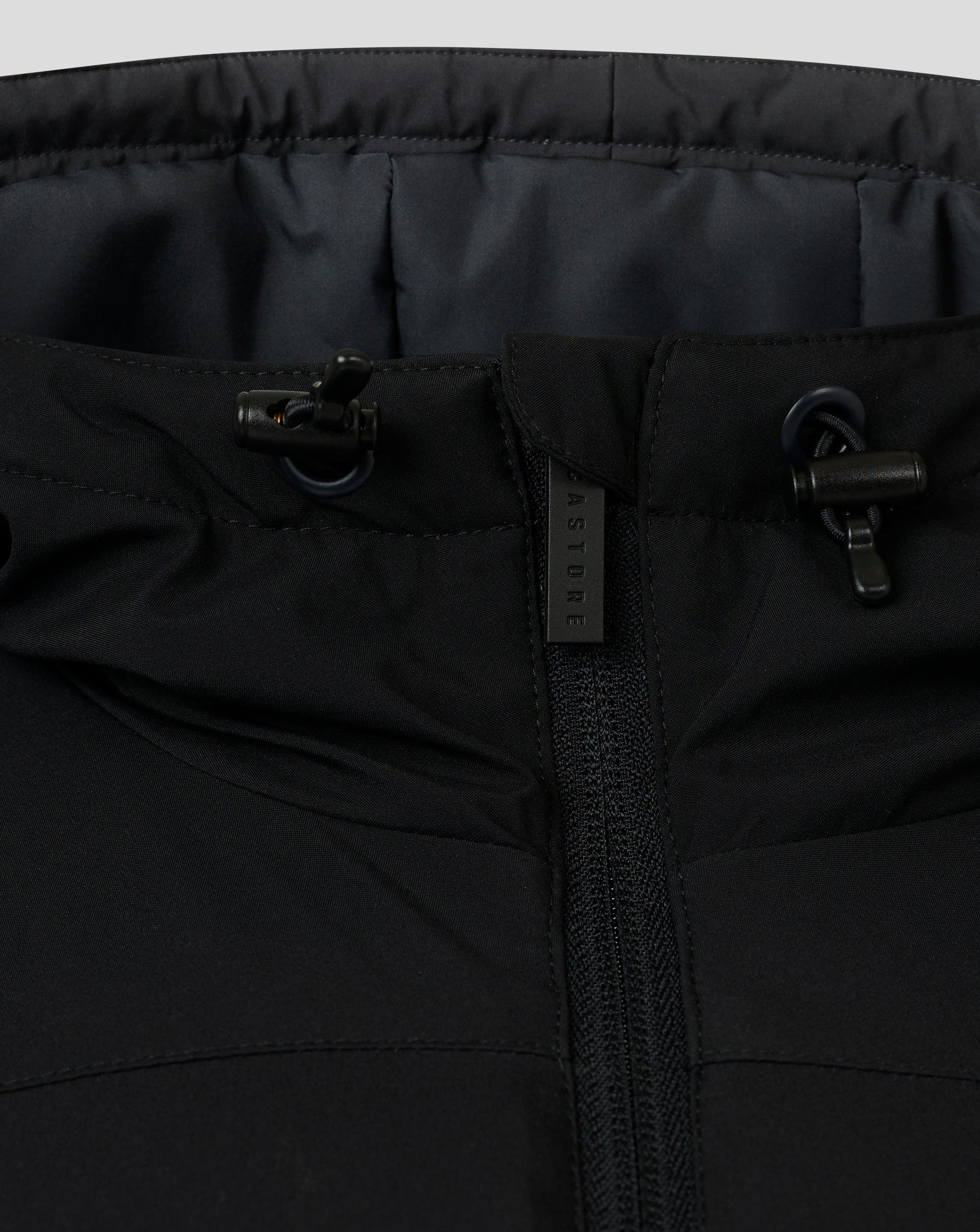 Close up of the jacket waist area with front zipper and adjustable drawcords