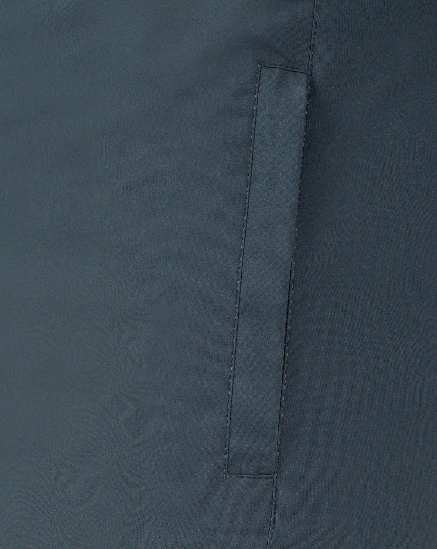 Close up of dark slate bench jacket fabric showing a vertical seam and strap detail.