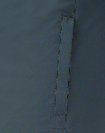 Close up of dark slate bench jacket fabric showing a vertical seam and strap detail.