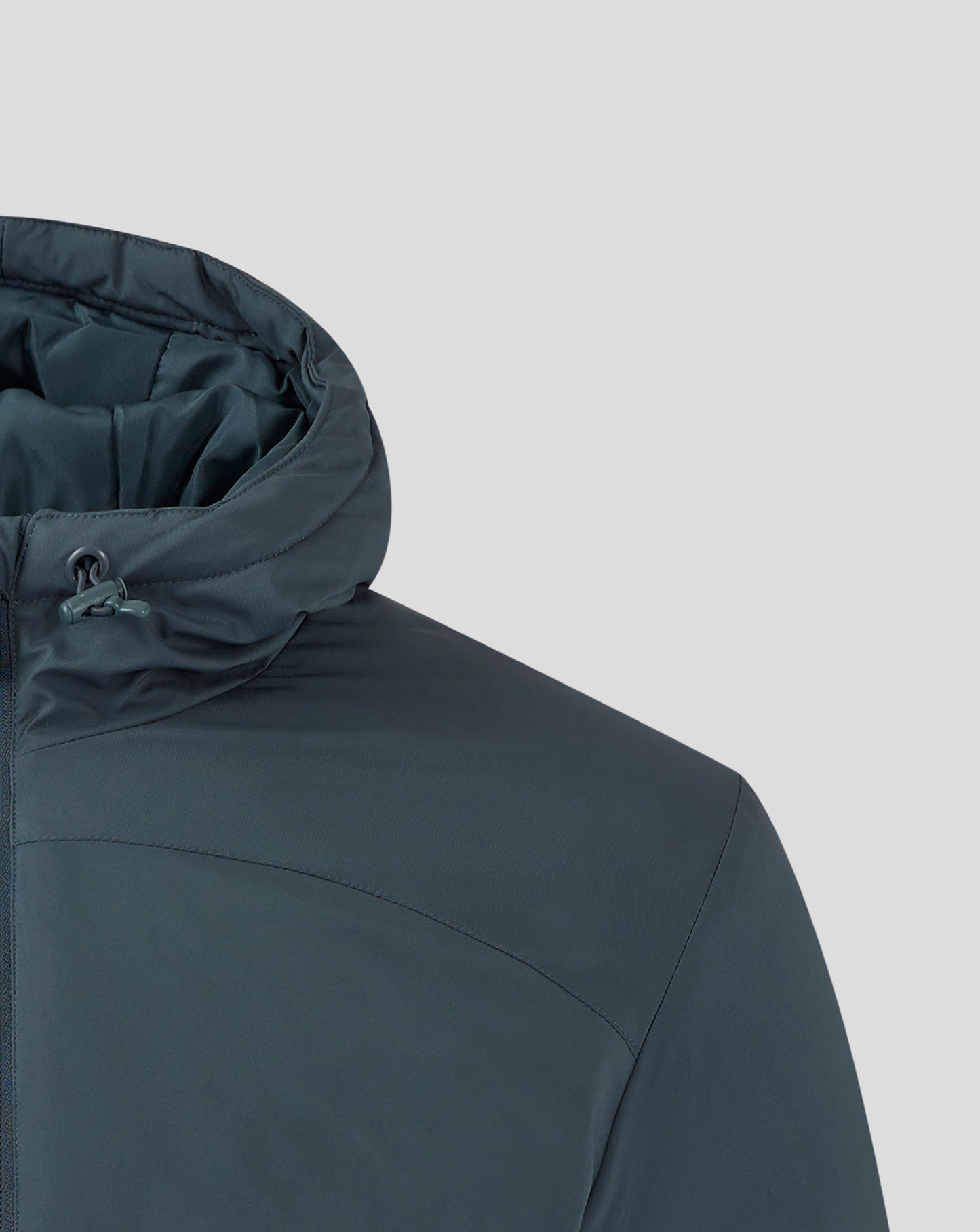Dark slate bench jacket with padded hood and white Castore wings logo on the chest.