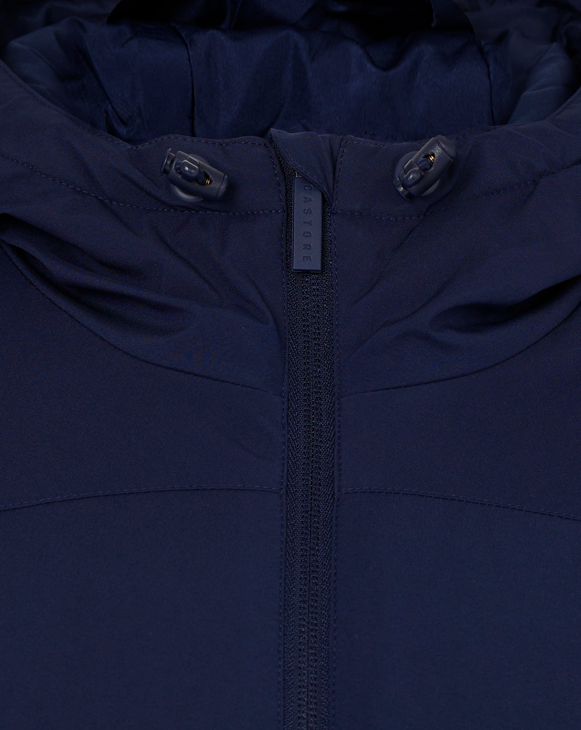 Close up of navy blue hooded jacket with hood toggle cords and center zipper