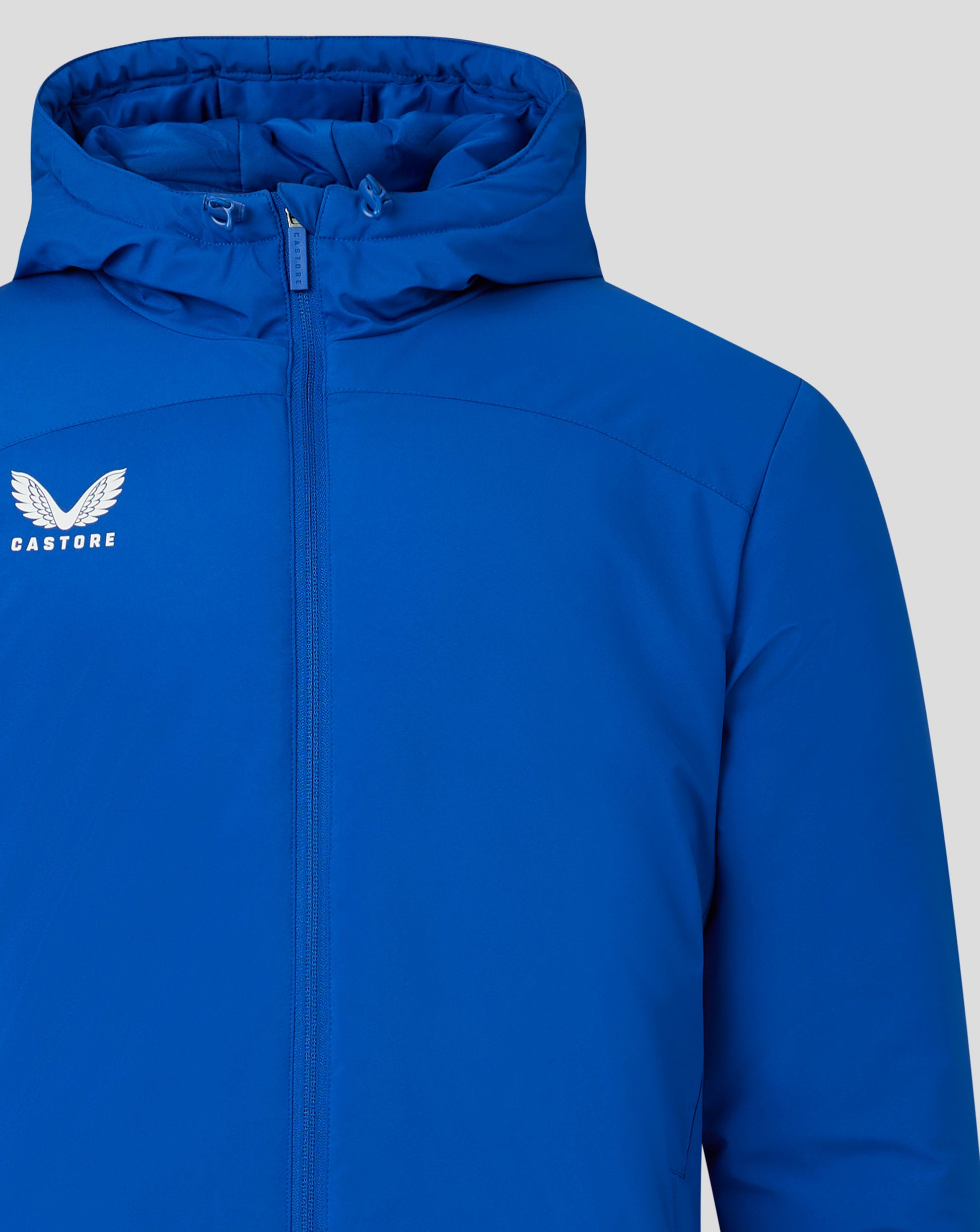 Blue padded mens jacket with a high hooded collar, full front zip and Castore logo on the left chest