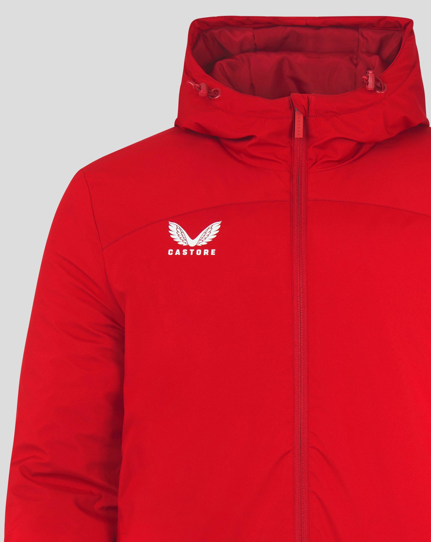 Close up of red Mens Bench Jacket showing hood with drawcords and front zipper with Castore logo on chest