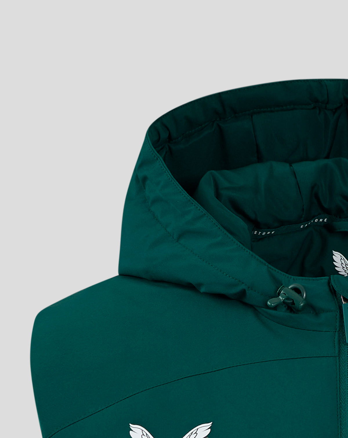 Close up of hood opening and interior of teal padded gilet with heat sealed Castore logo