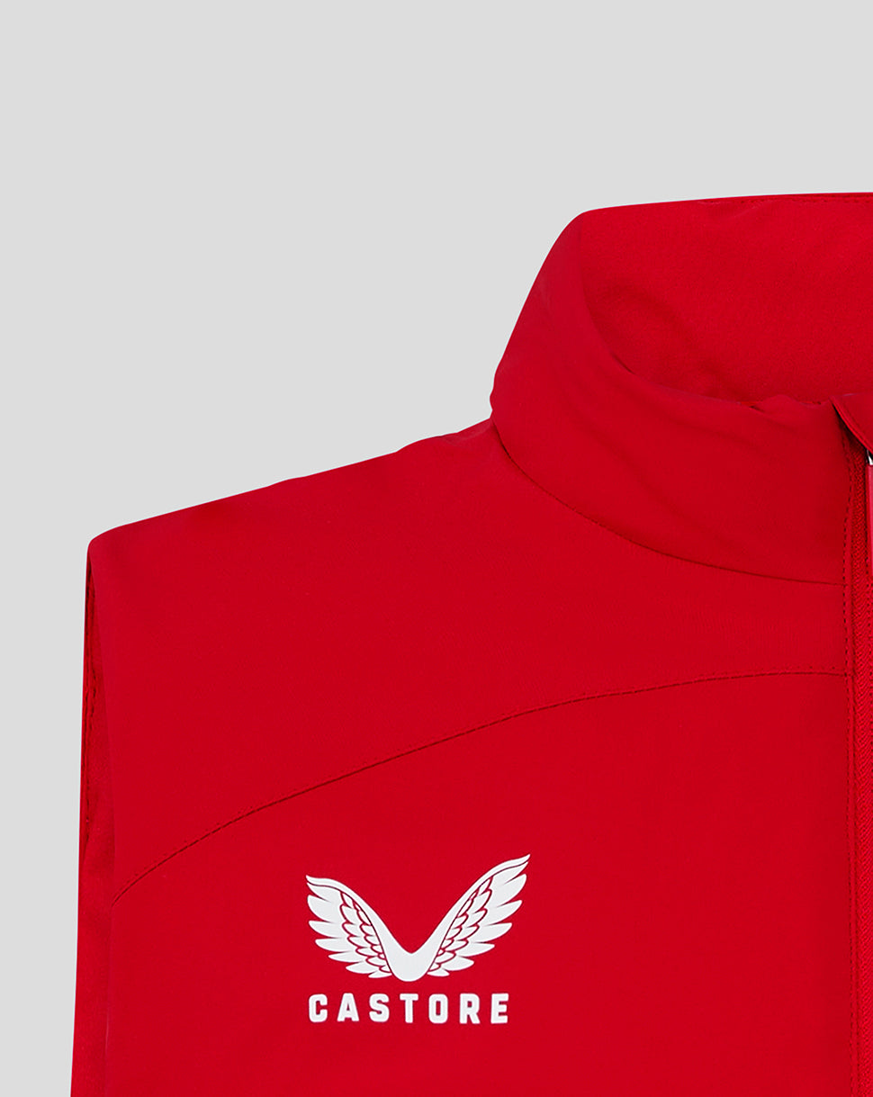 Close-up of red padded gilet chest with white Castore logo and wings.