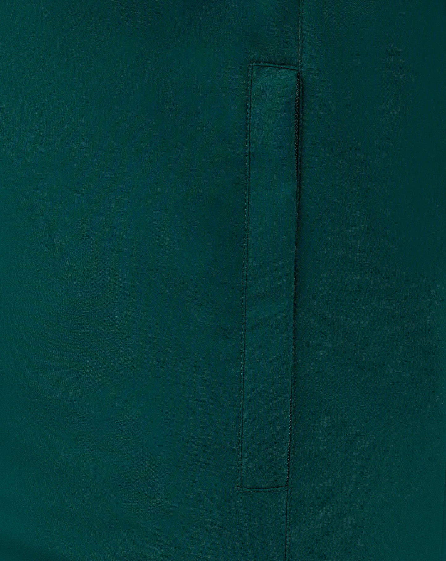 Close up of teal padded gilet fabric showing a vertical seam and pocket detail