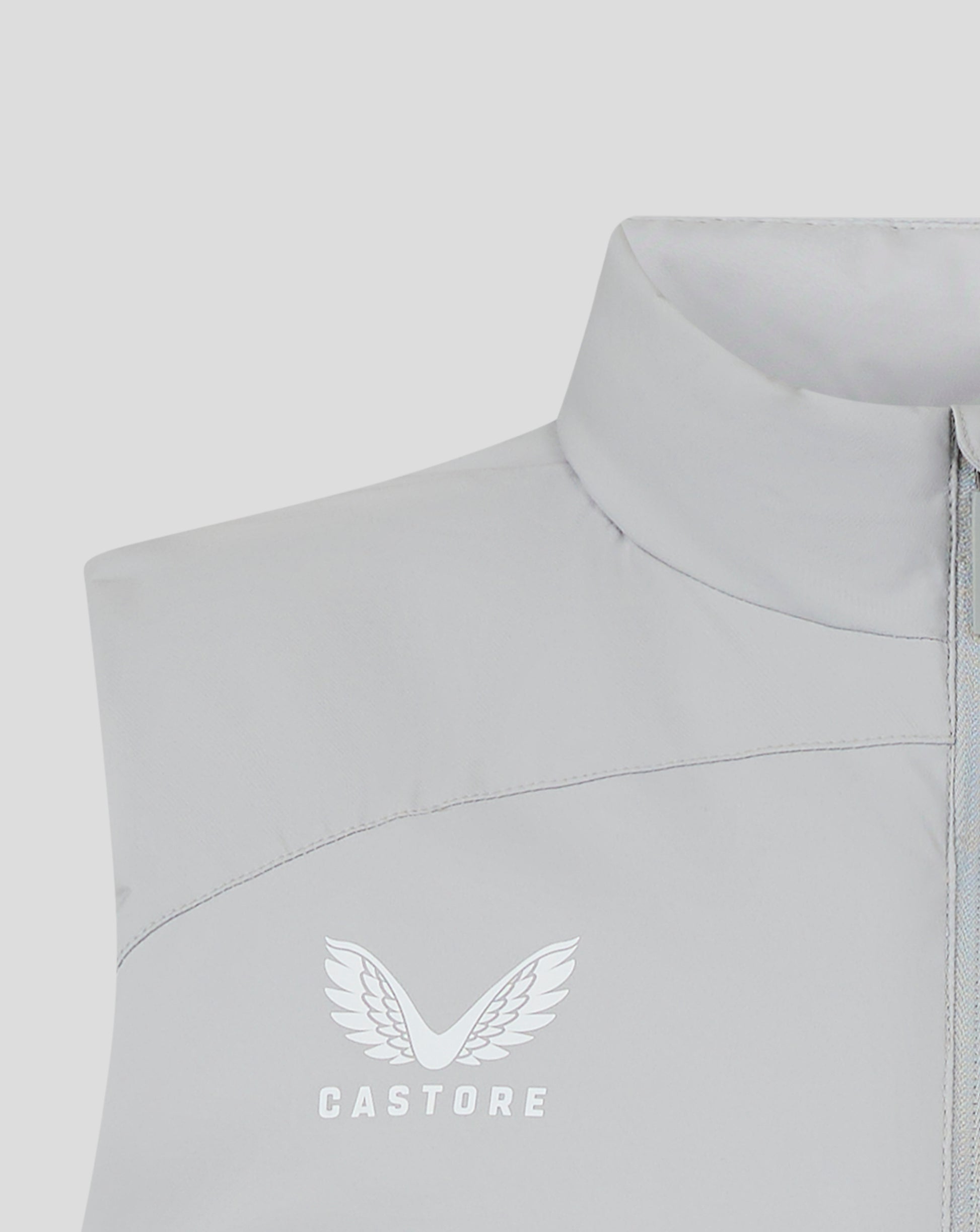 Close up of light gray padded gilet collar with zipper and Castore branding on the placket