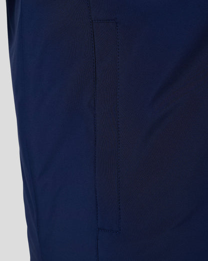 Close up of navy padded gilet fabric showing a vertical pocket seam and clean stitching.