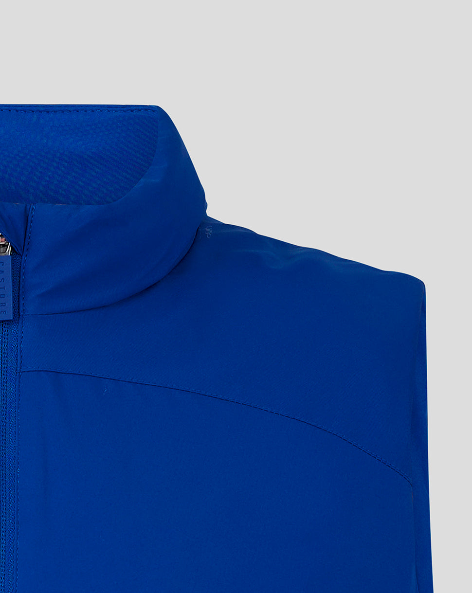 Close up of blue padded gilet collar and shoulder with zipper detail.