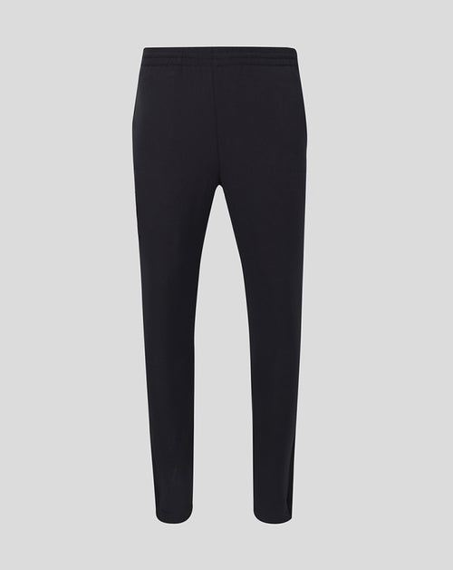 Back view of black men's track pants with an elastic waistband and tapered legs.