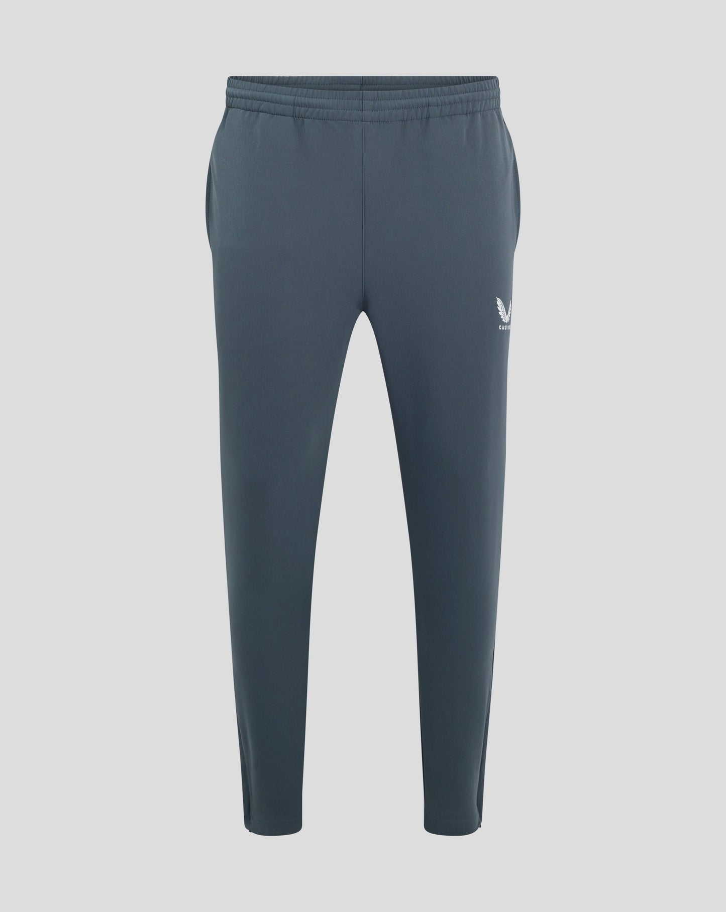 Back view of dark slate track pants with elastic waistband and Castore logo on the hip