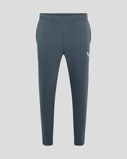 Back view of dark slate track pants with elastic waistband and Castore logo on the hip