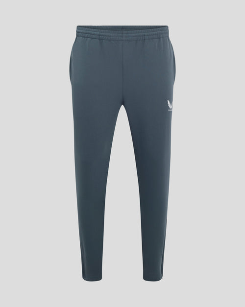 Back view of dark slate track pants with elastic waistband and Castore logo on the hip