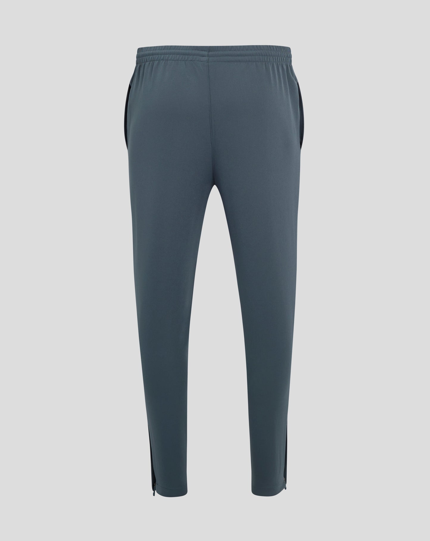 Back view of dark slate track pants with central seam and tapered legs