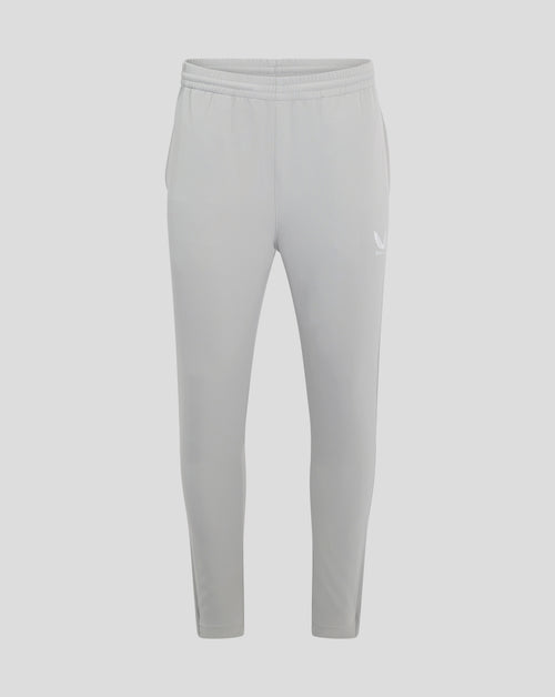 Back view of light grey track pants with elastic waistband and a small Castore wing logo at the thigh.