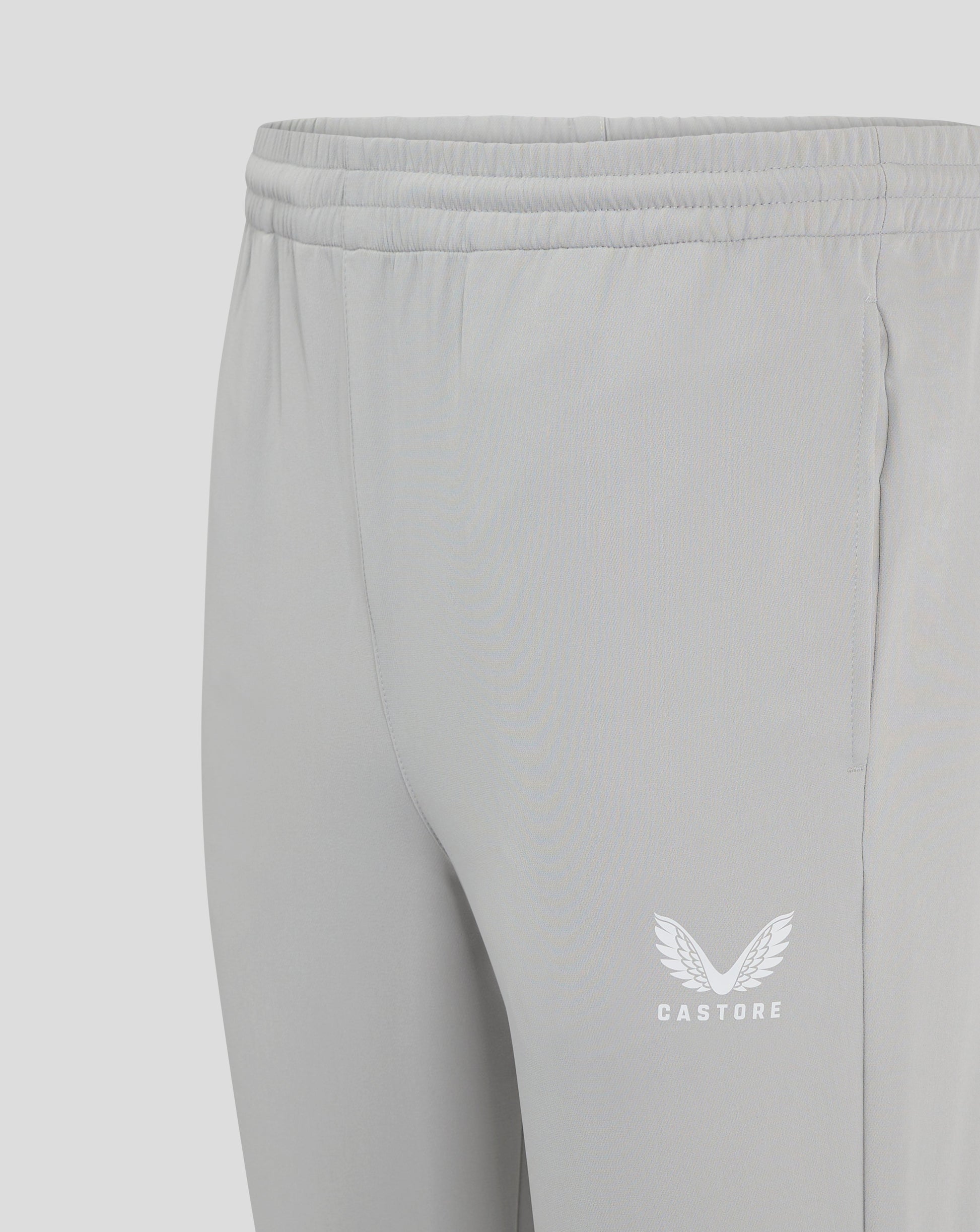 Close up of the elastic waistband with drawcord on light gray track pants
