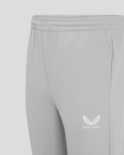 Close up of the elastic waistband with drawcord on light gray track pants