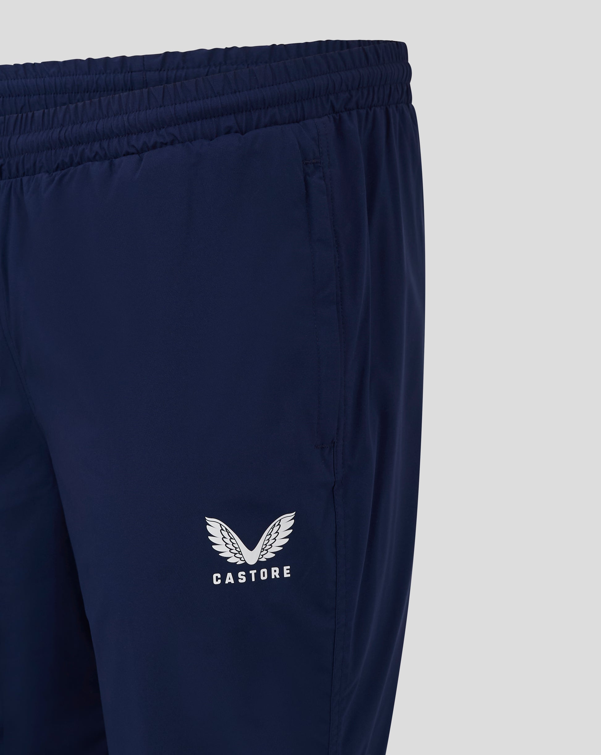 Close up of navy pant leg with Castore wings logo