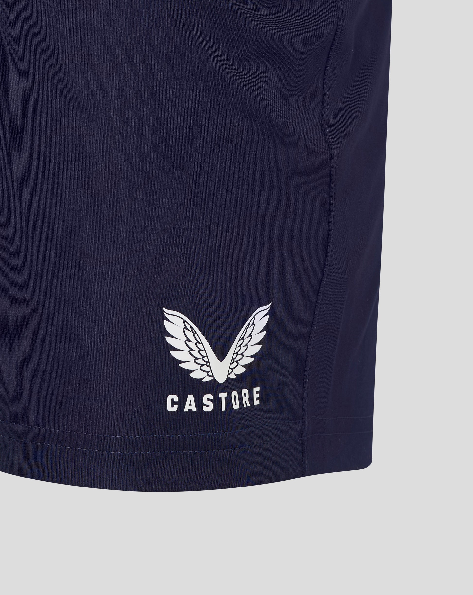 Back of navy shorts with large Castore emblem and CASTORE text on the lower leg