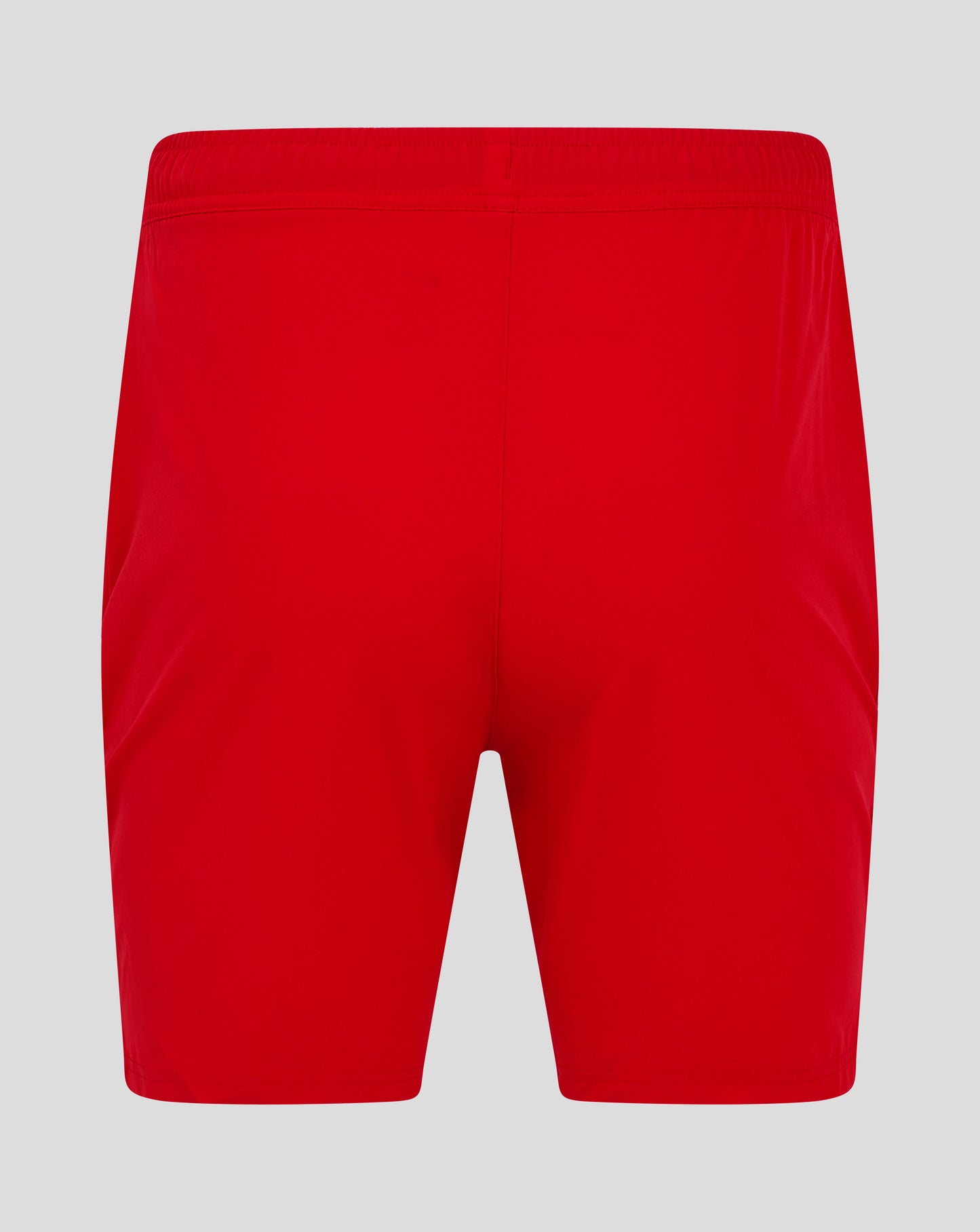 Back view of bright red mens woven training shorts with an elastic waistband and central seam.