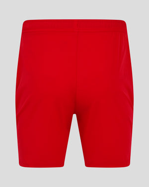Back view of bright red mens woven training shorts with an elastic waistband and central seam.