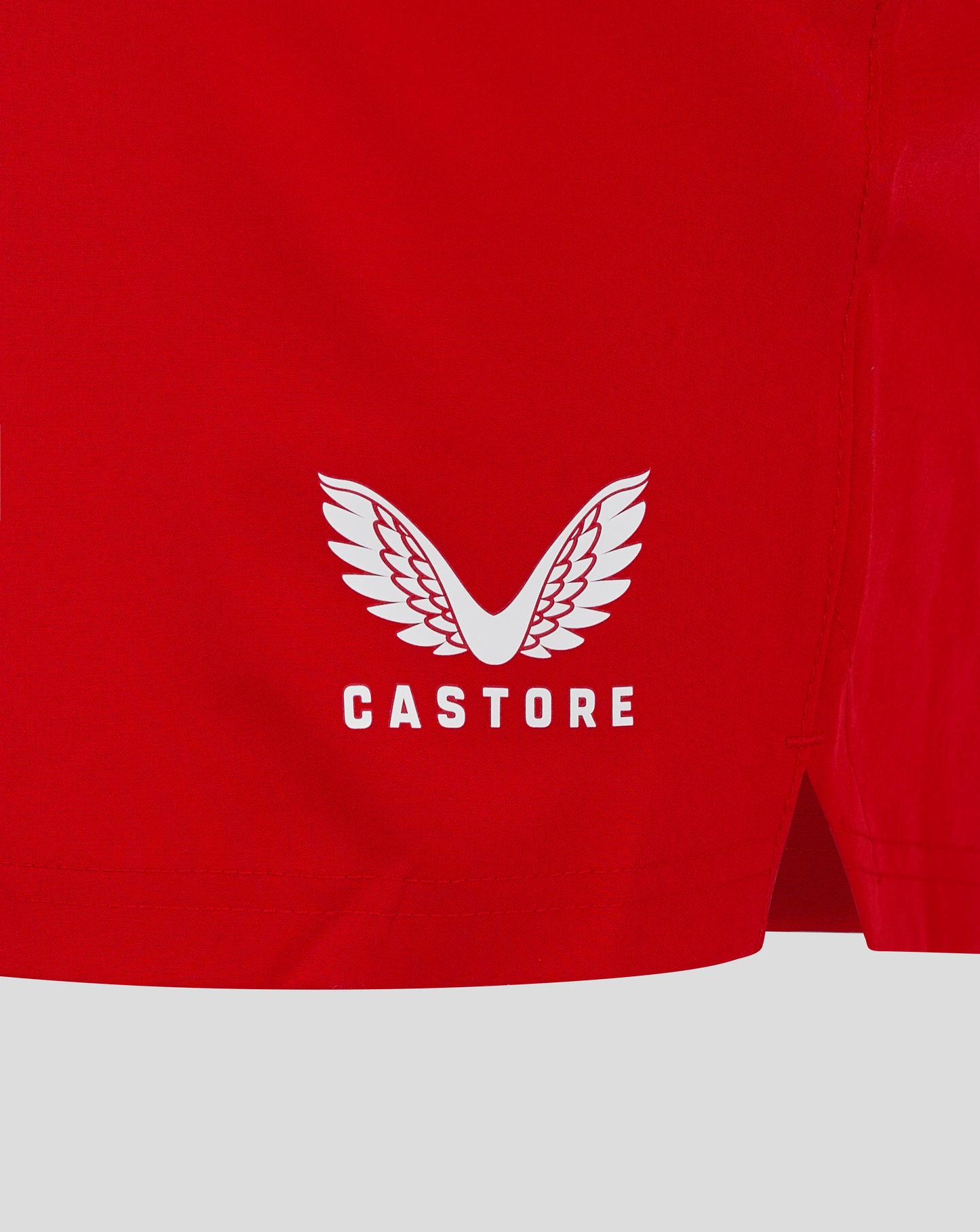 Back view of red shorts with white Castore wing logo near the hem.