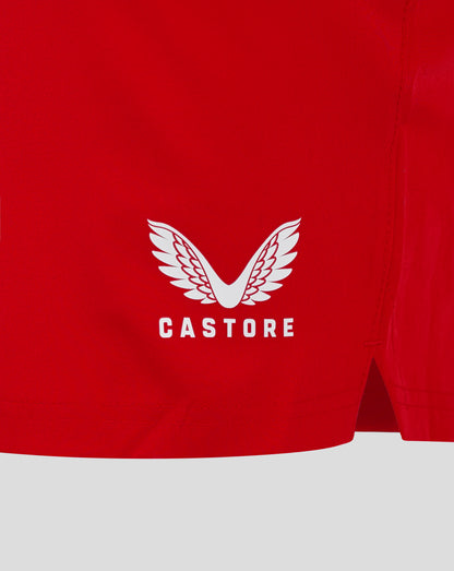 Back view of red shorts with white Castore wing logo near the hem.