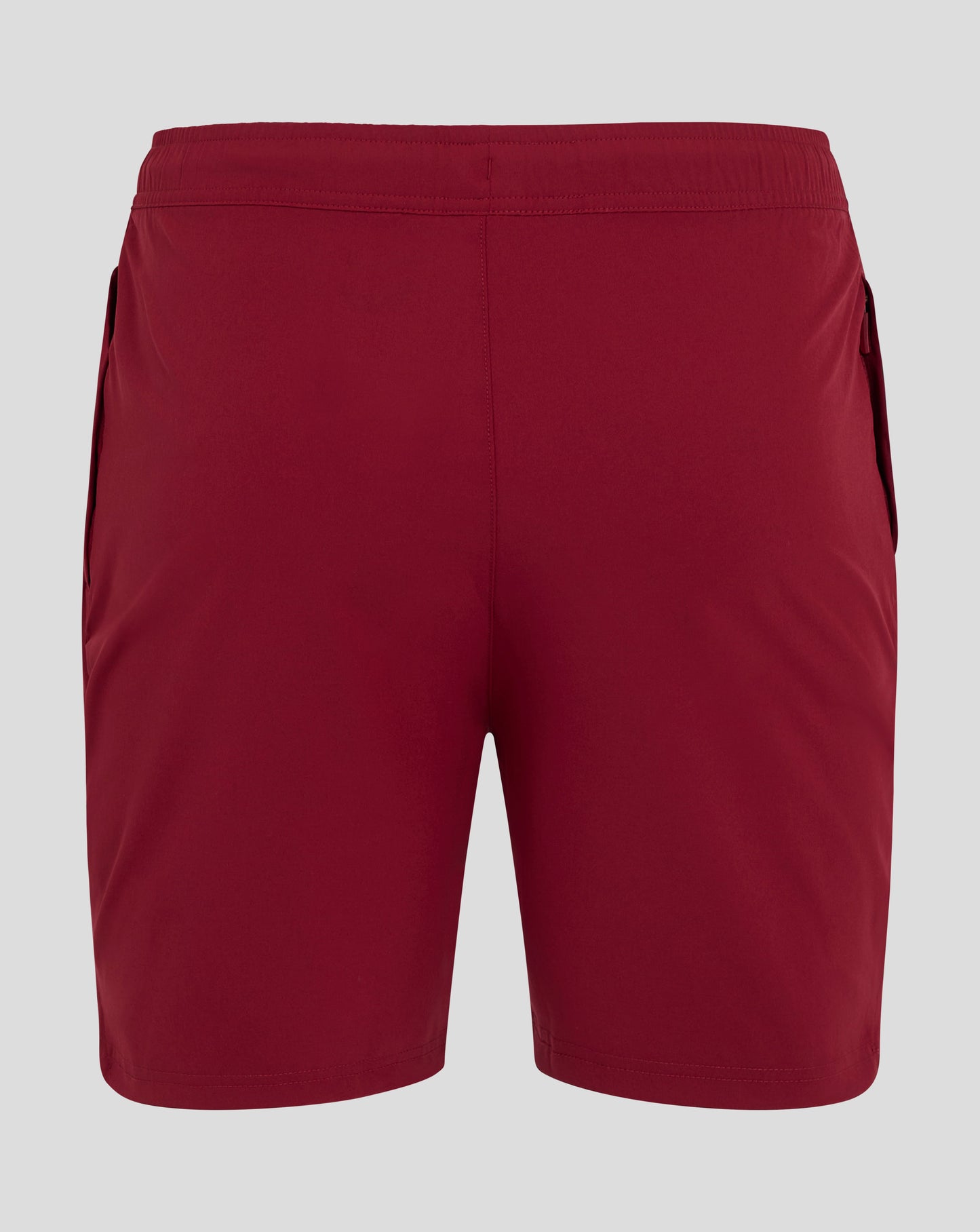 Red woven training shorts with Castore logo on the lower leg