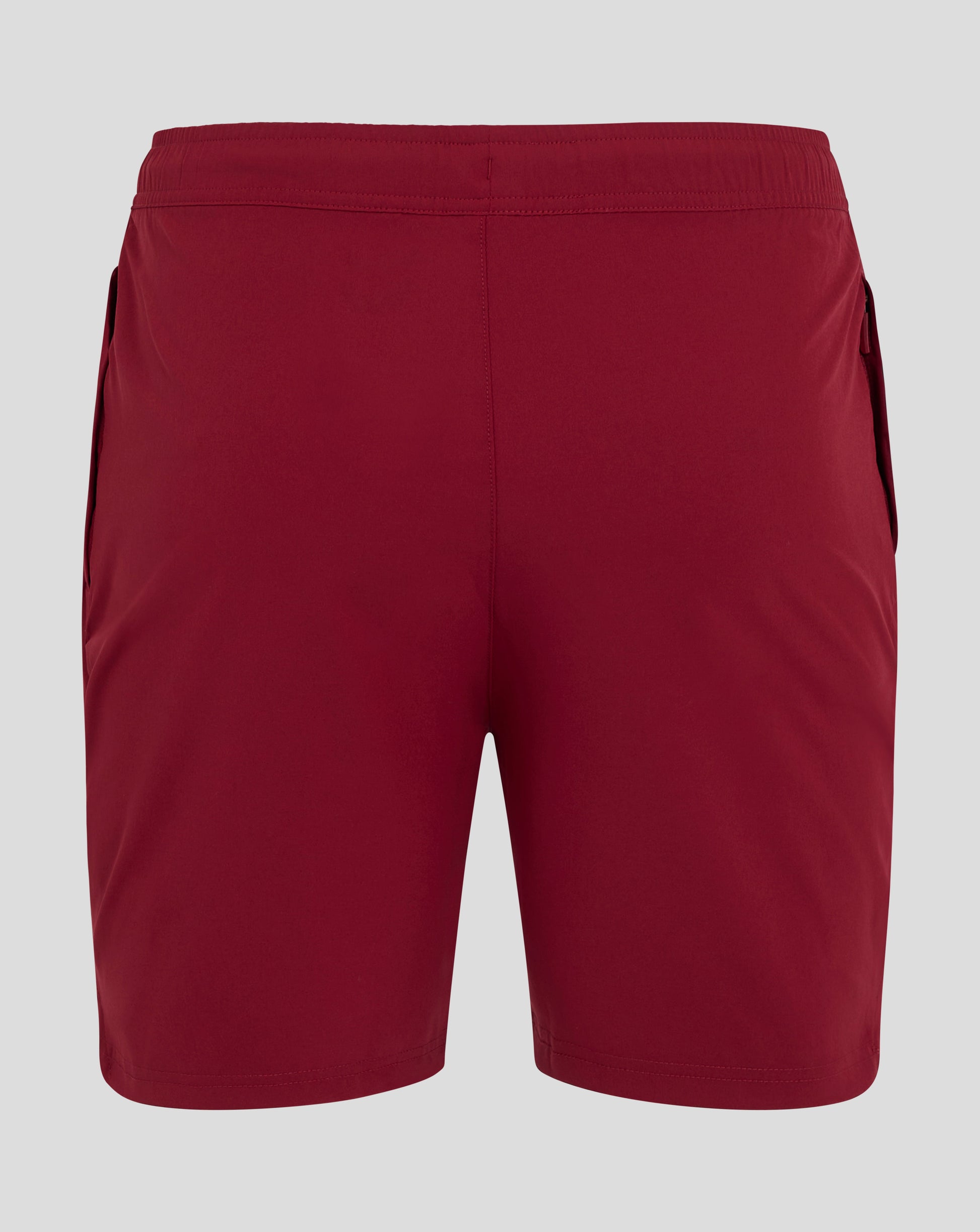 Red woven training shorts with Castore logo on the lower leg