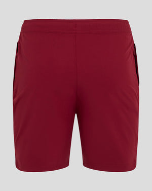 Red woven training shorts with Castore logo on the lower leg