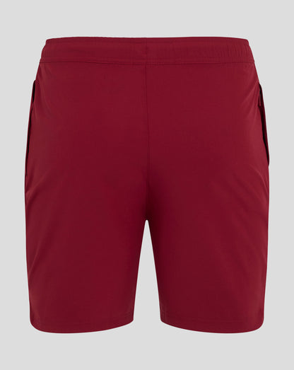 Red woven training shorts with Castore logo on the lower leg