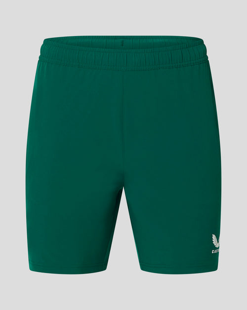 Back view of green Botanical Garden woven training shorts with elastic waistband and Castore logo at the leg hem.