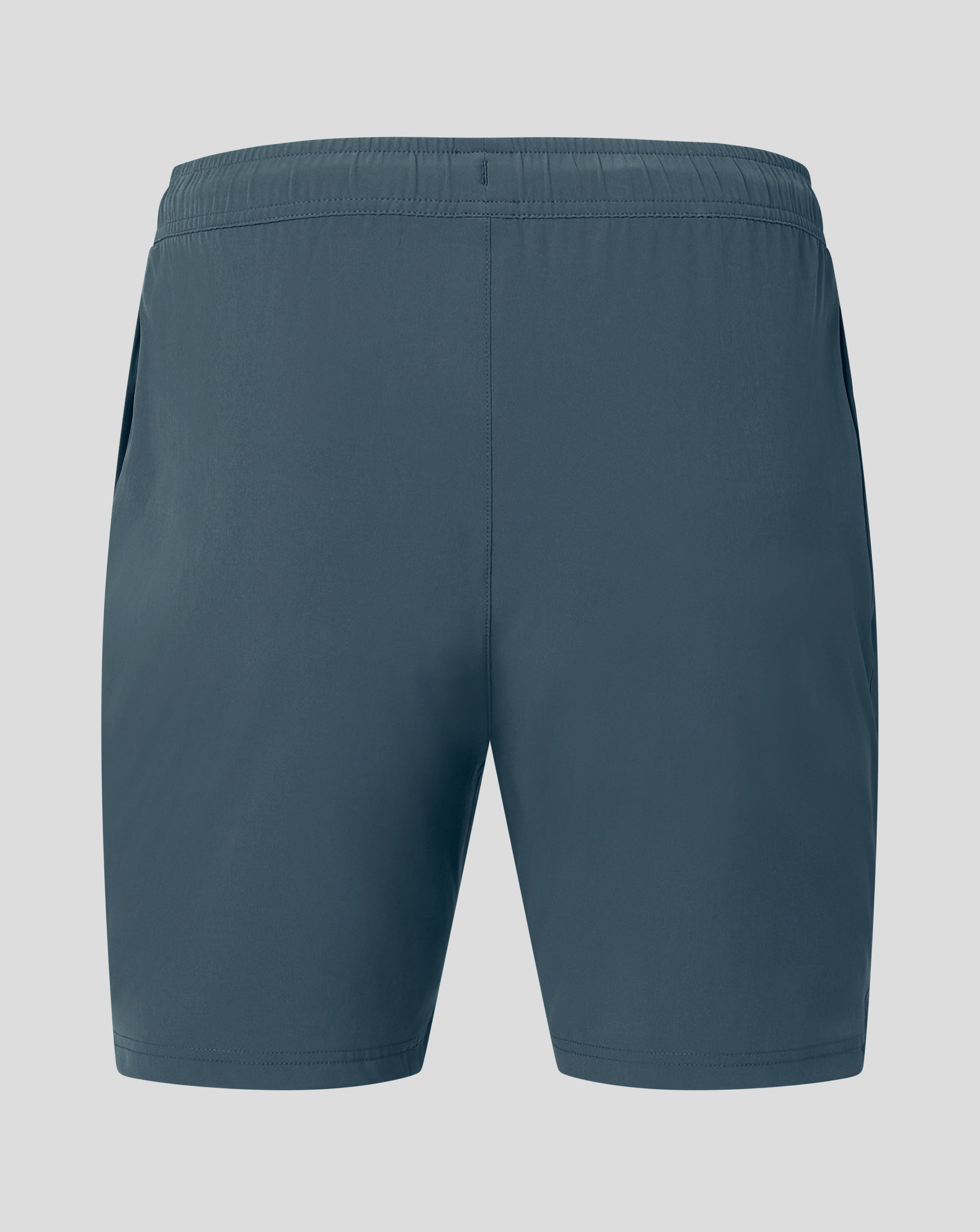 Back view of dark slate woven training shorts with elastic waistband and Castore logo on the hem
