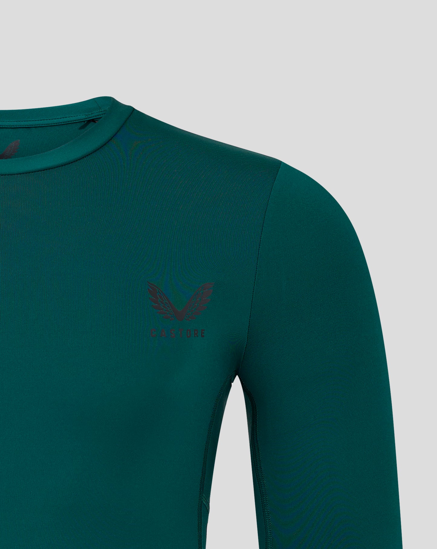 Teal botanical garden baselayer long sleeve top close up of neck and chest with Castore logo