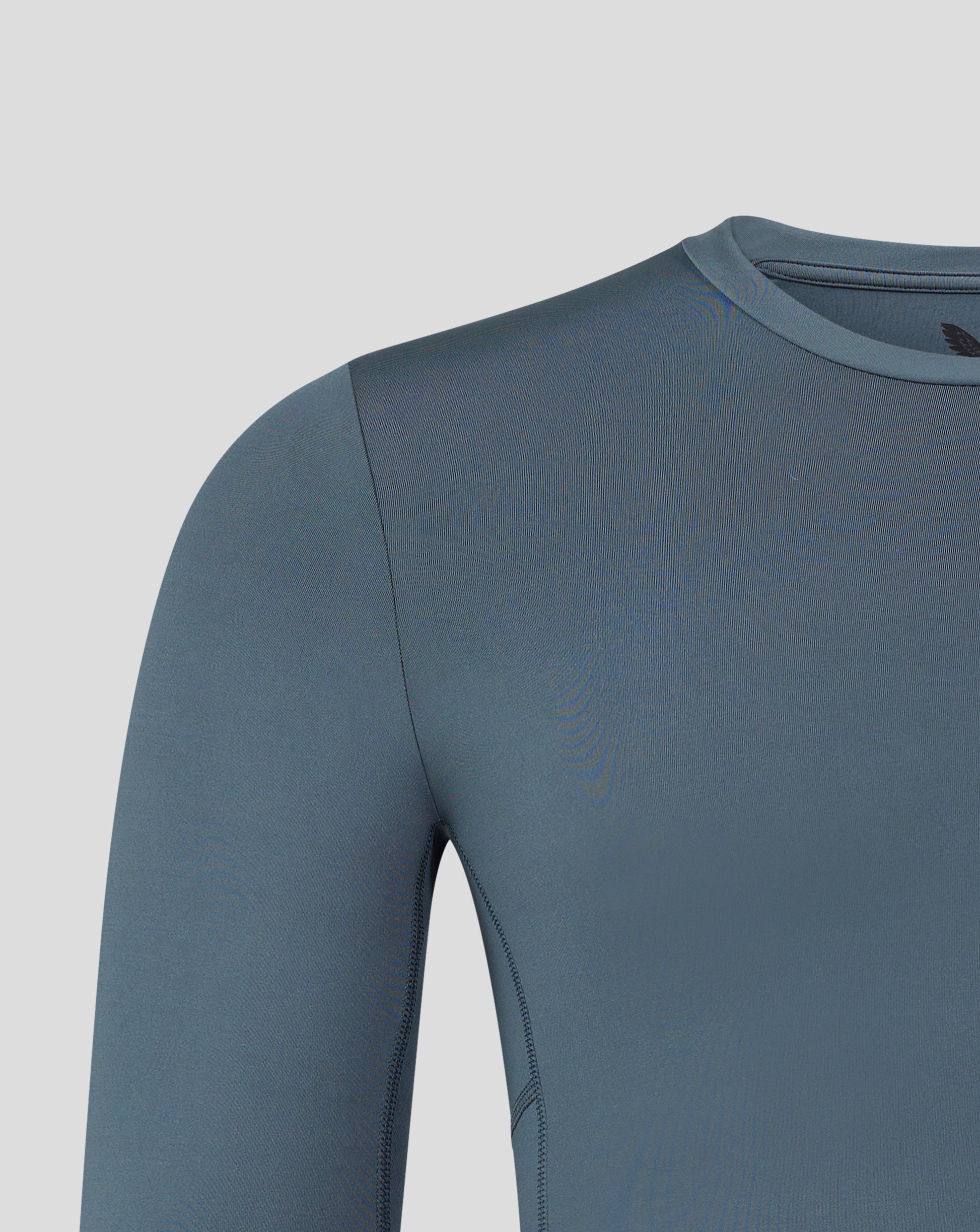 Shoulder and upper chest close up on dark slate baselayer with logo