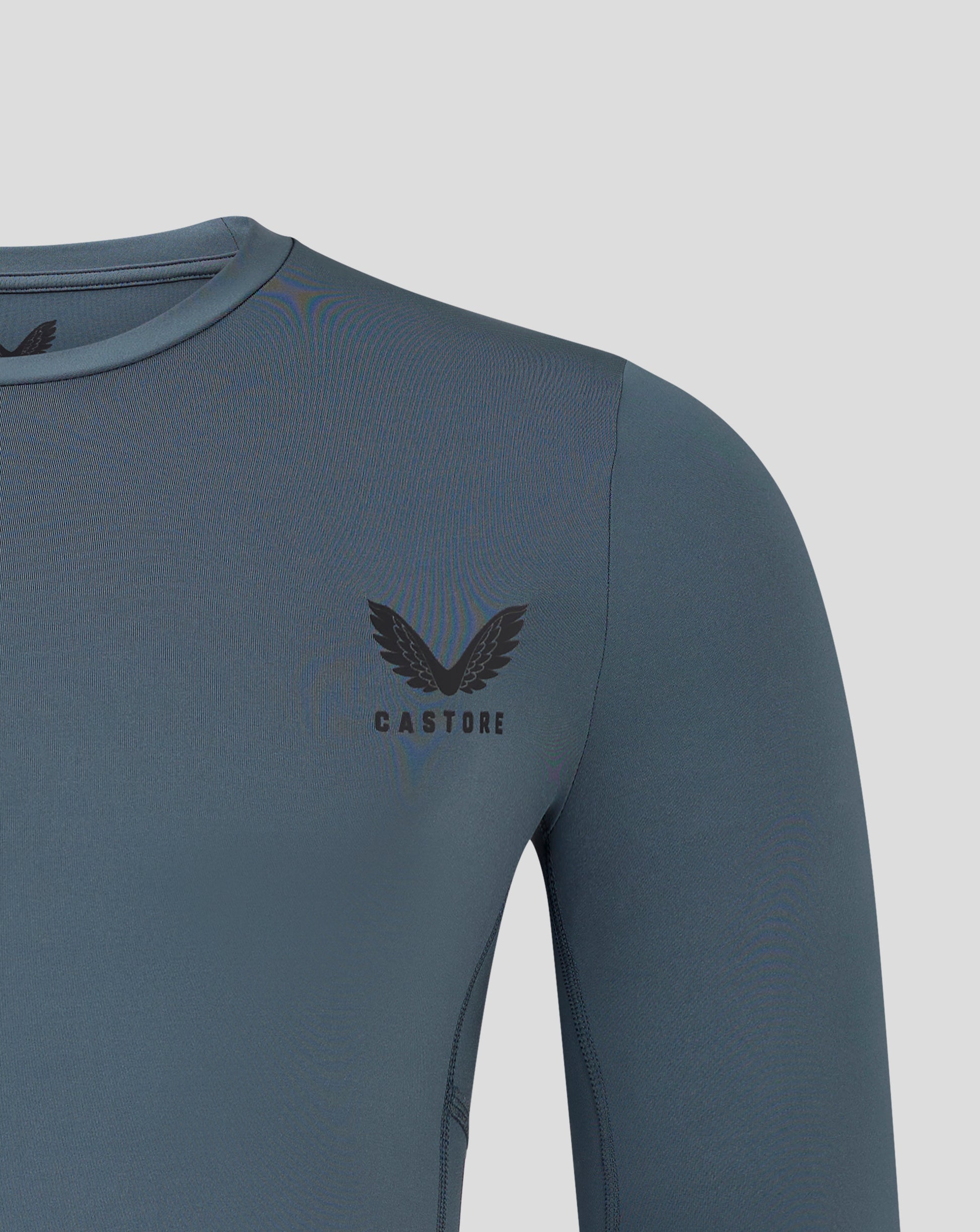 Chest area of dark slate baselayer with Castore logo visible near the chest