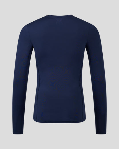 Back view of navy peacoat Baselayer long sleeve top with upper back logo and clean seam lines