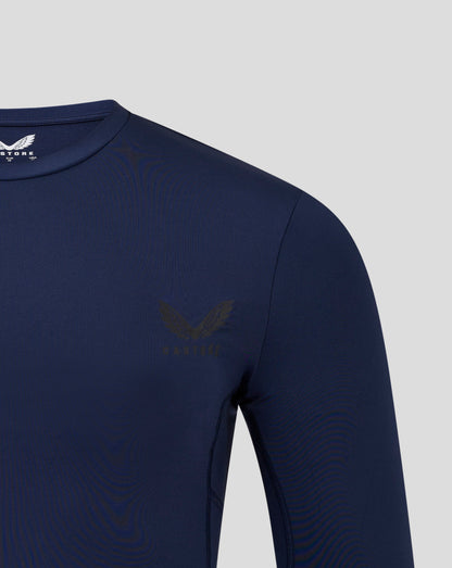 Navy mens Baselayer Long Sleeve Top close up of shoulder and chest with crew neck collar and visible side panels and heat sealed Castore logo