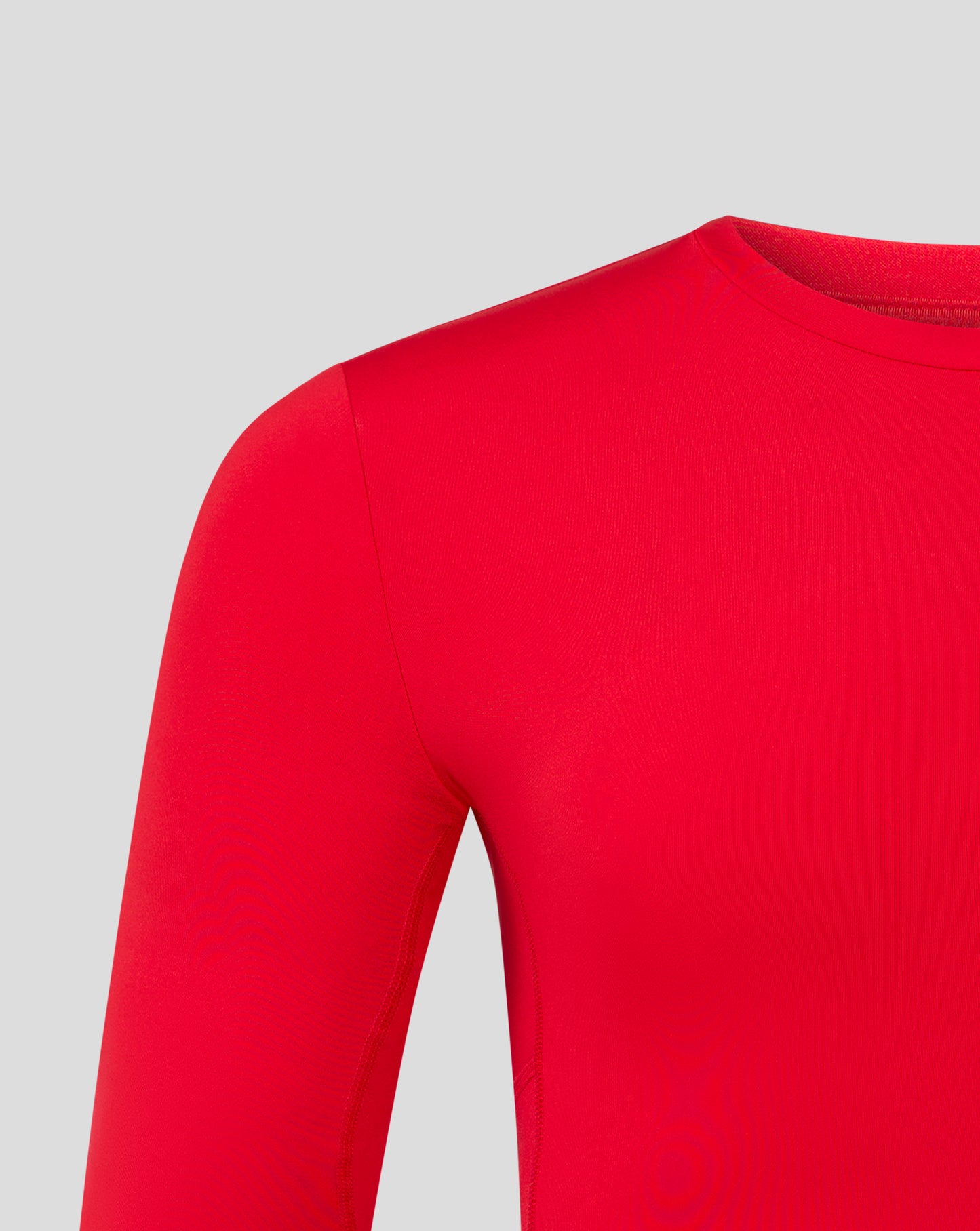 Close up of red baselayer sleeve and shoulder showing smooth fabric and seam
