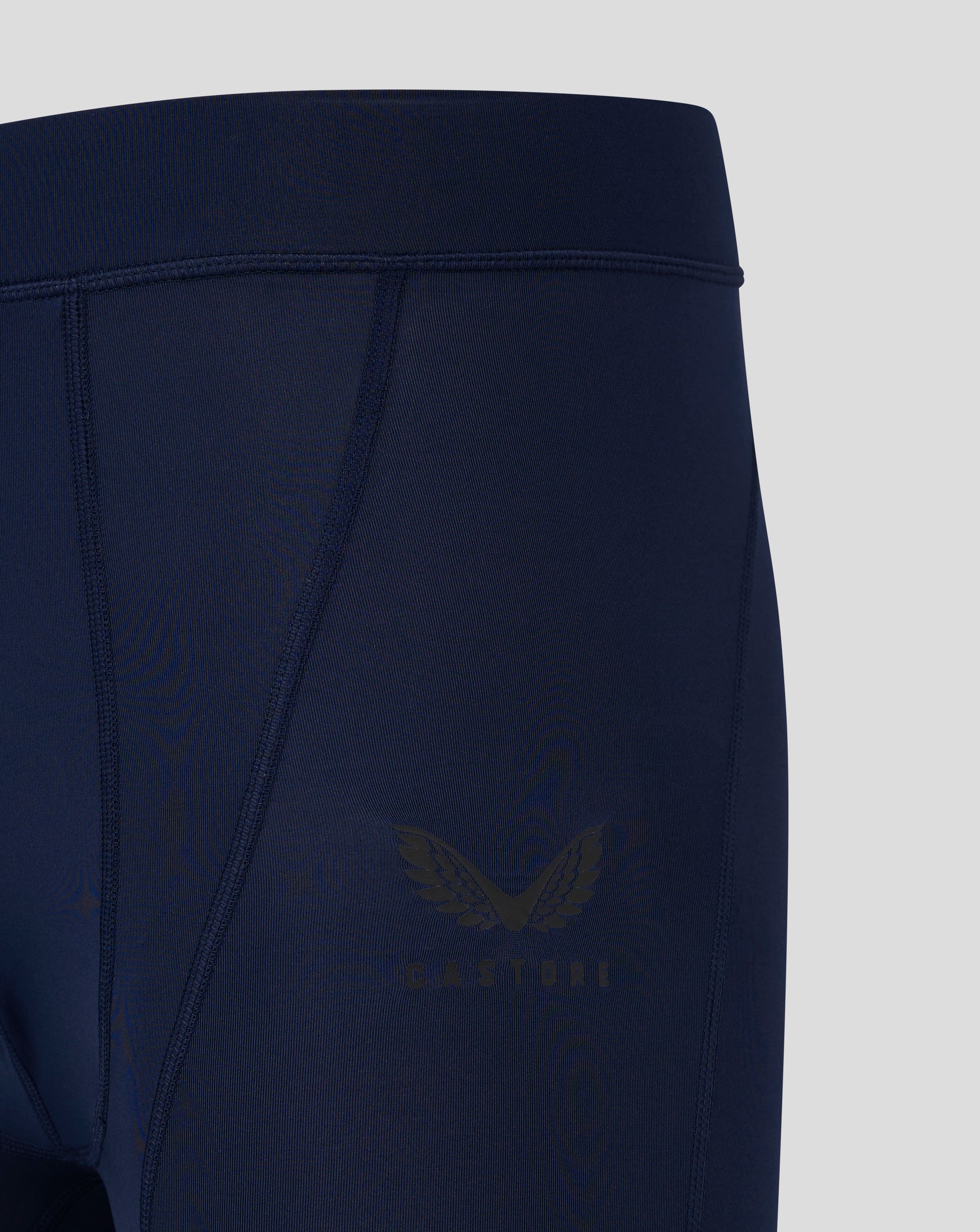 Close up of navy Peacoat baselayer legging highlighting waistband and seam panel detailing