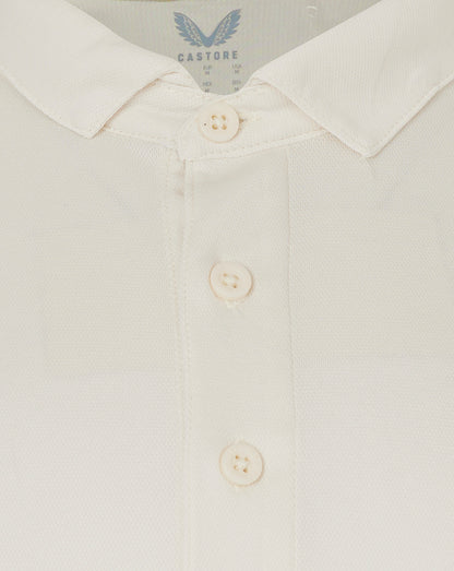 Close up of collar and button placket on cream polo showing textured fabric.