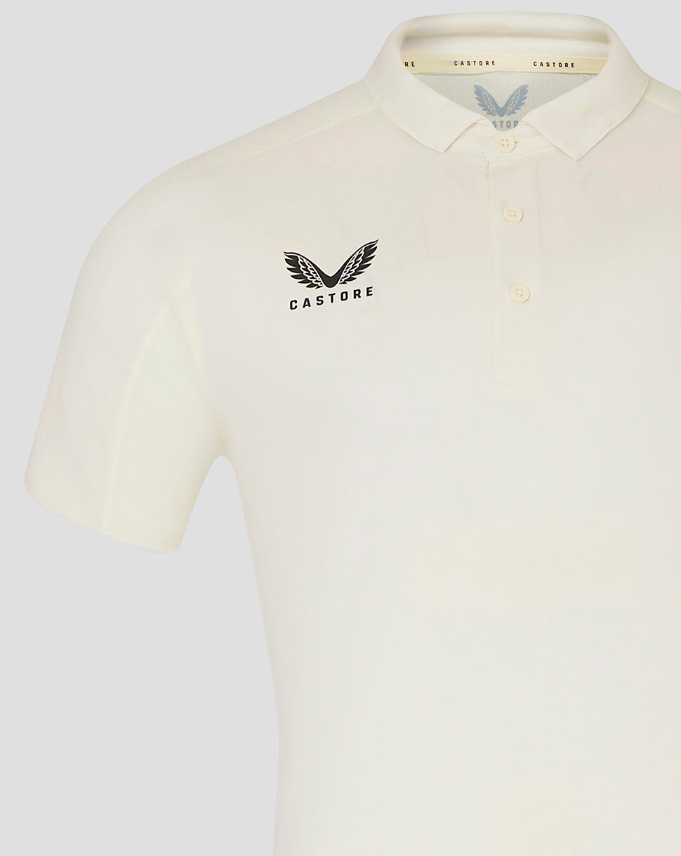 Cream mens cricket polo with winged Castore logo on chest and subtle collar detail