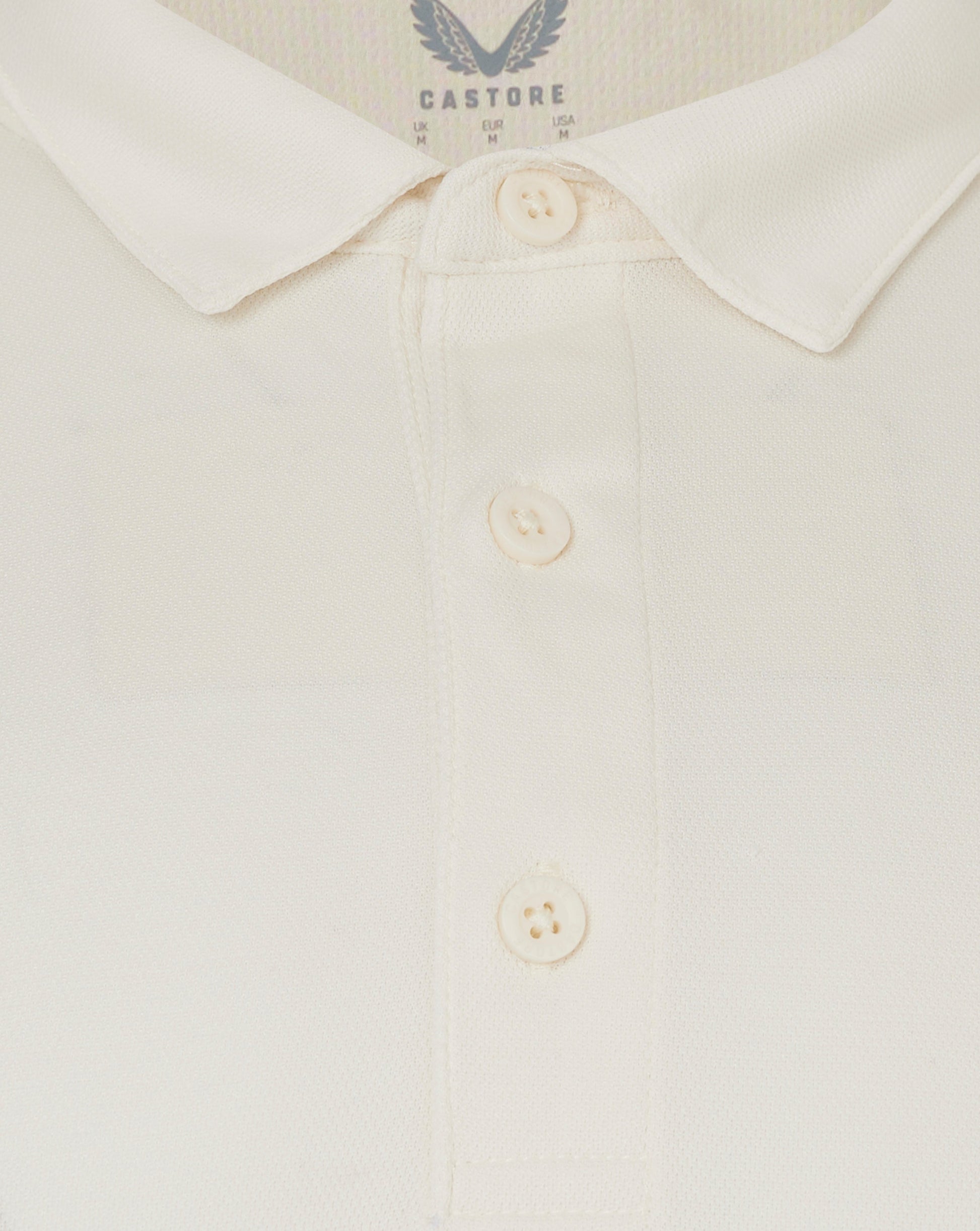 Close up of Cannoli Cream long sleeve cricket shirt collar with button placket and heat sealed Castore logo