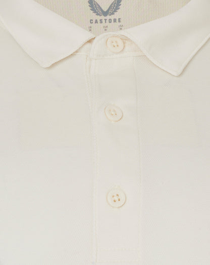Close up of Cannoli Cream long sleeve cricket shirt collar with button placket and heat sealed Castore logo