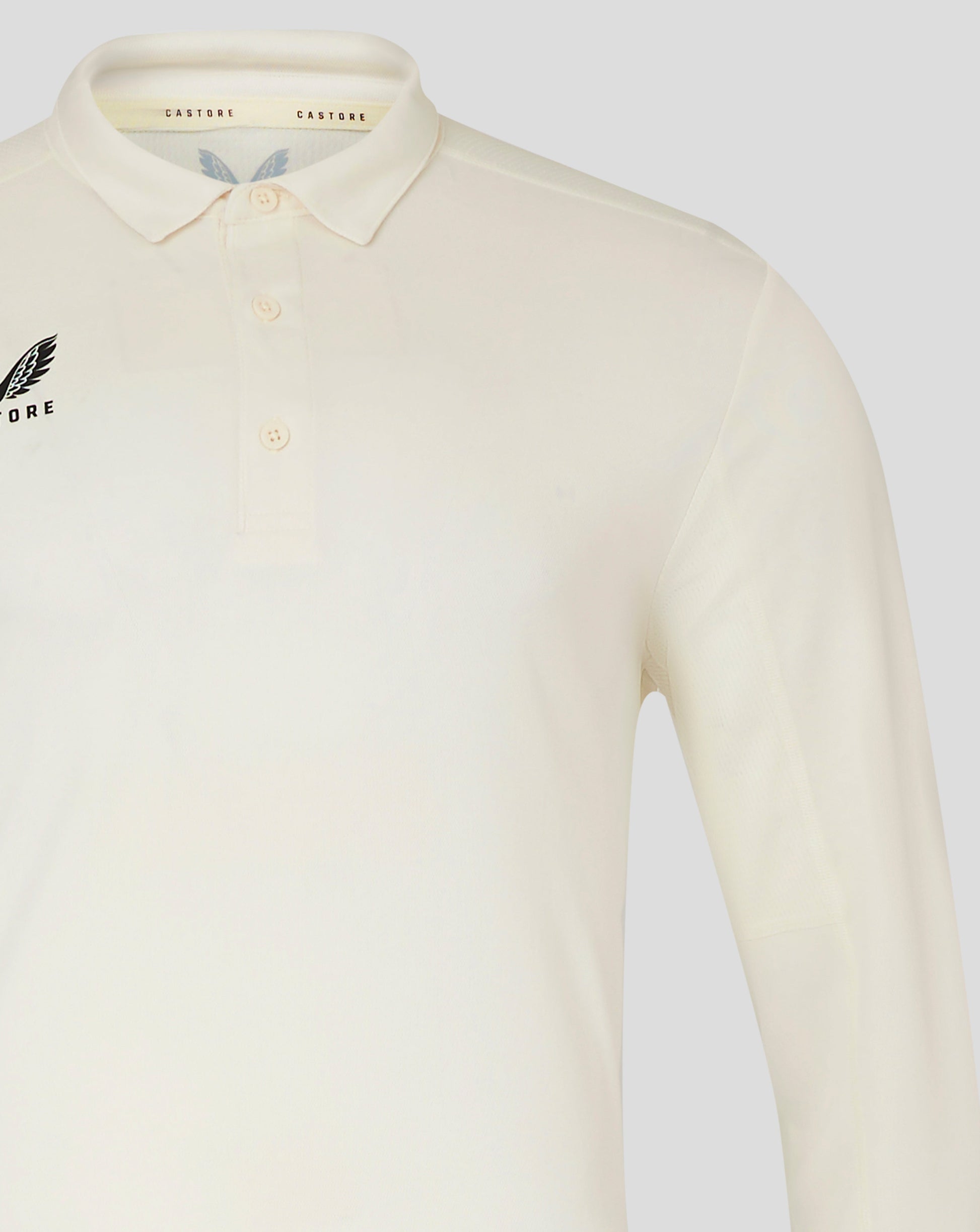 Shoulder and sleeve detail of Cannoli Cream cricket shirt with pale fabric and neat stitching