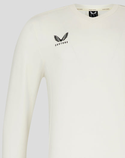 Left chest view of Cannoli Cream cricket jumper with Castore logo and neck label visible.
