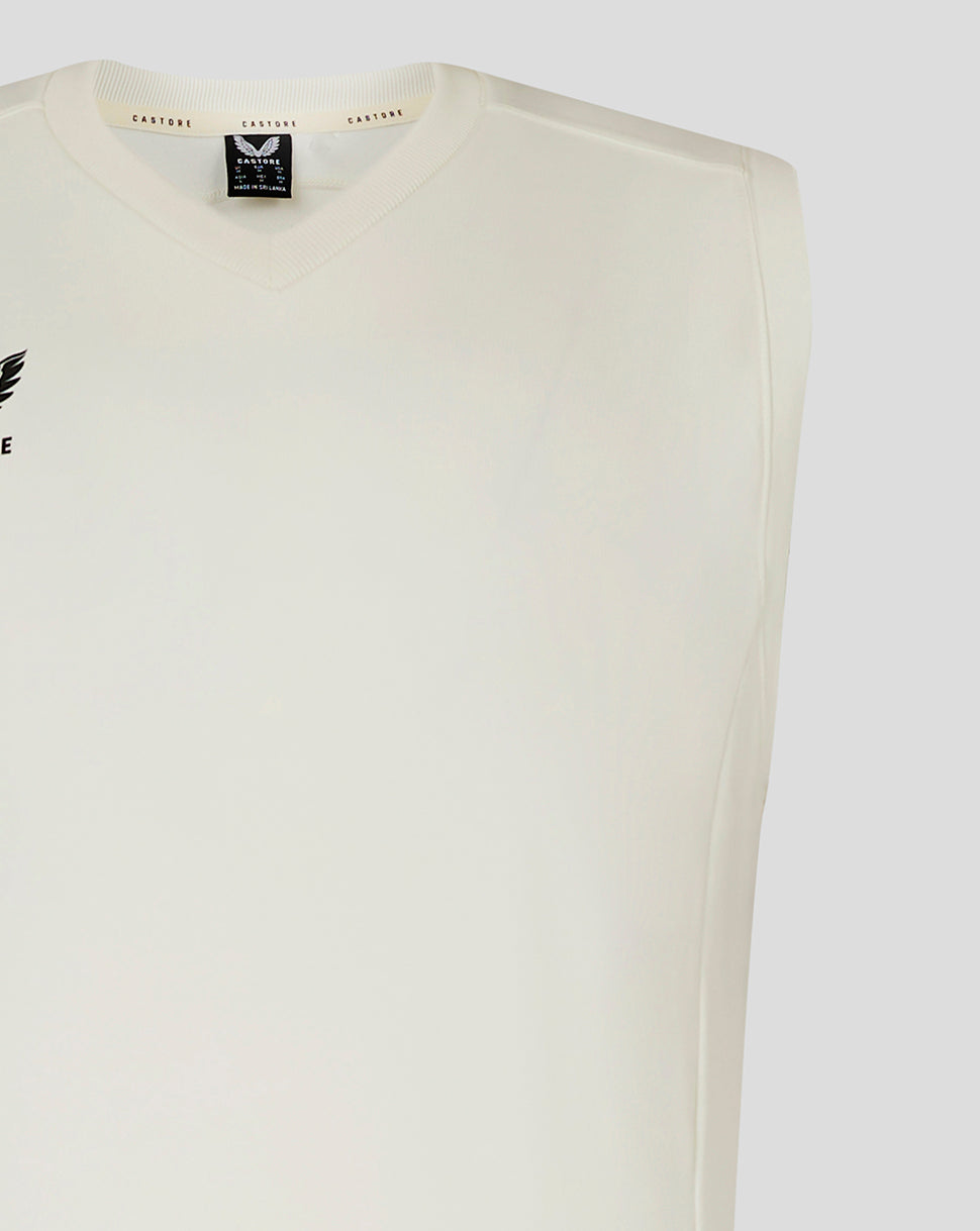 Close-up of neckline showing Castore label and logo on white sleeveless cricket vest