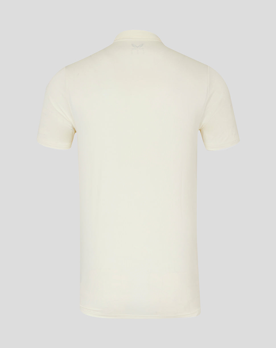 Back view of cream cricket short sleeve tech polo showing clean silhouette