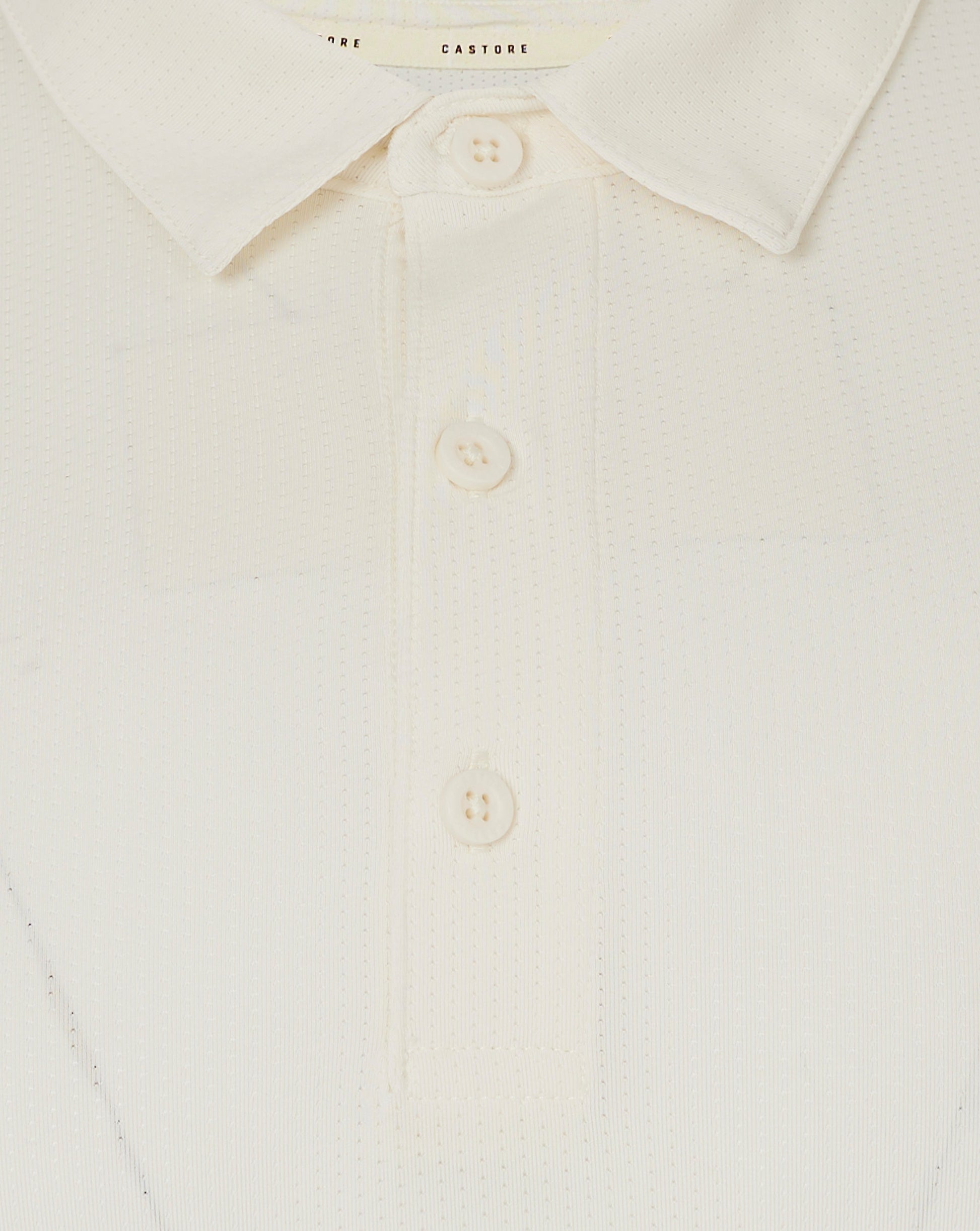 Close up of collar and three button placket on Cannoli Cream Castore cricket shirt