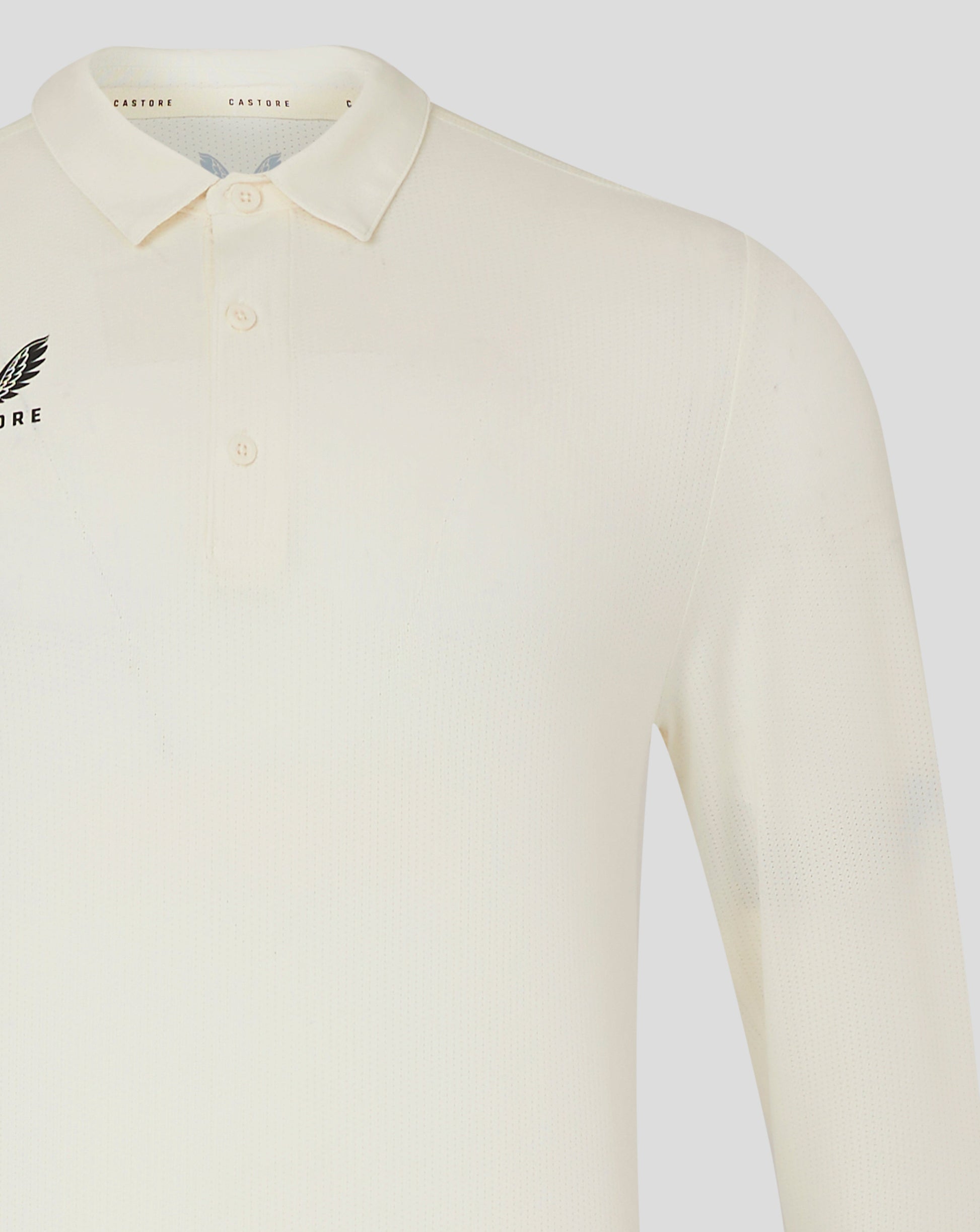 Front view of Cannoli Cream Castore cricket shirt with collar and small chest logo